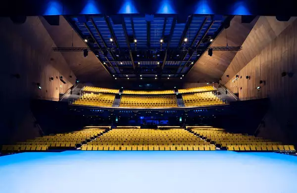Photo of the stage and yellow seats in the Hall
