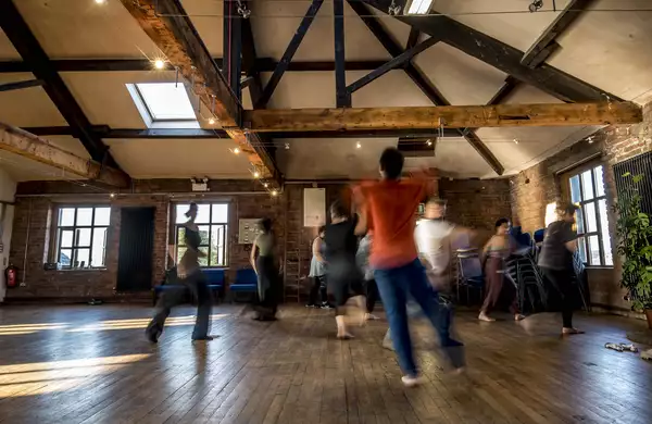 Photo of blurry people moving in a studio