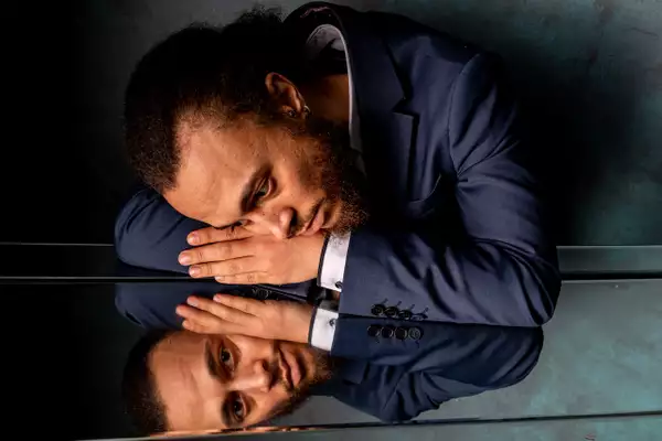 Photo of AJ Leroy and their reflection