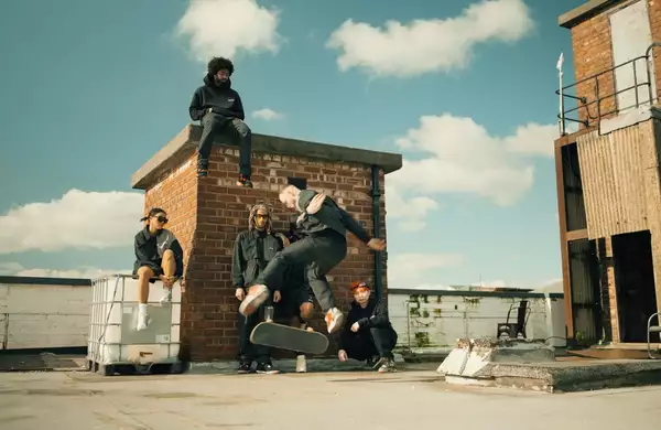 Photo of a group of skateboarders practising on a roof