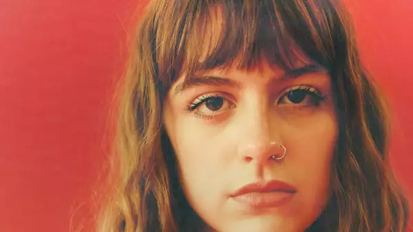 Close-up shot of Chloe Slater on a red background