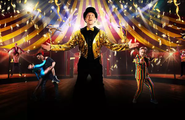 A vibrant circus scene with acrobats, dancers, a ringmaster in gold, and a clown in a striped suit under a big top with confetti.