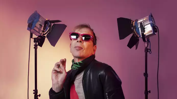 David Hoyle wearing sunglasses with two camera lights