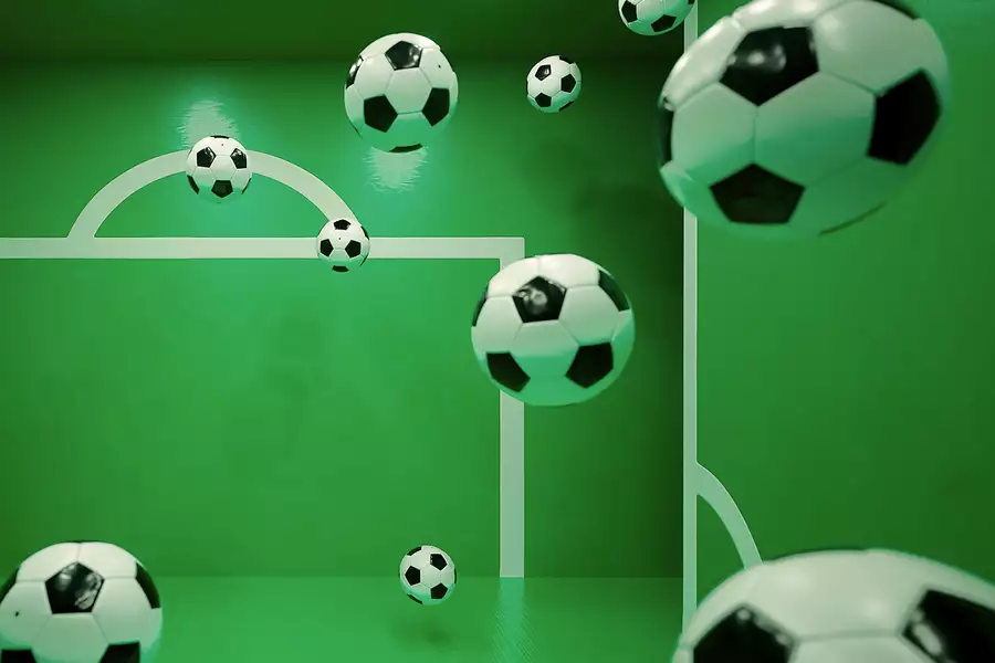 Multiple floating soccer balls inside a green room with white goalpost markings on the walls. The perspective and reflections create an illusion of depth, making it appear as if the balls are suspended in mid-air.
