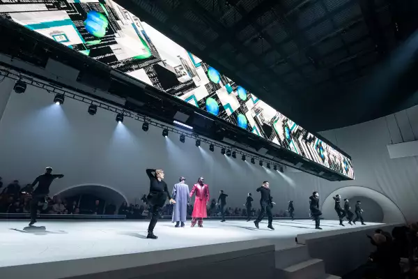 Dancers on the runway in Free Your Mind underneath lit up screens