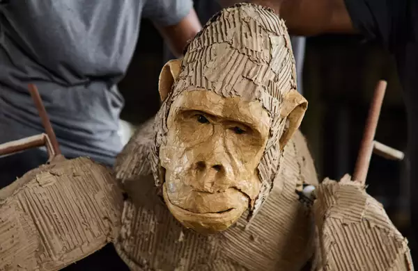 A close-up of a cardboard puppet of a gorilla