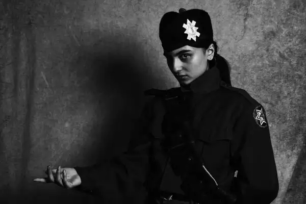 A black and white photography of the musician Heartworms wearing a military inspired outfit