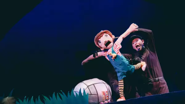 Photo of Pui-ka Cheng on stage with a puppet