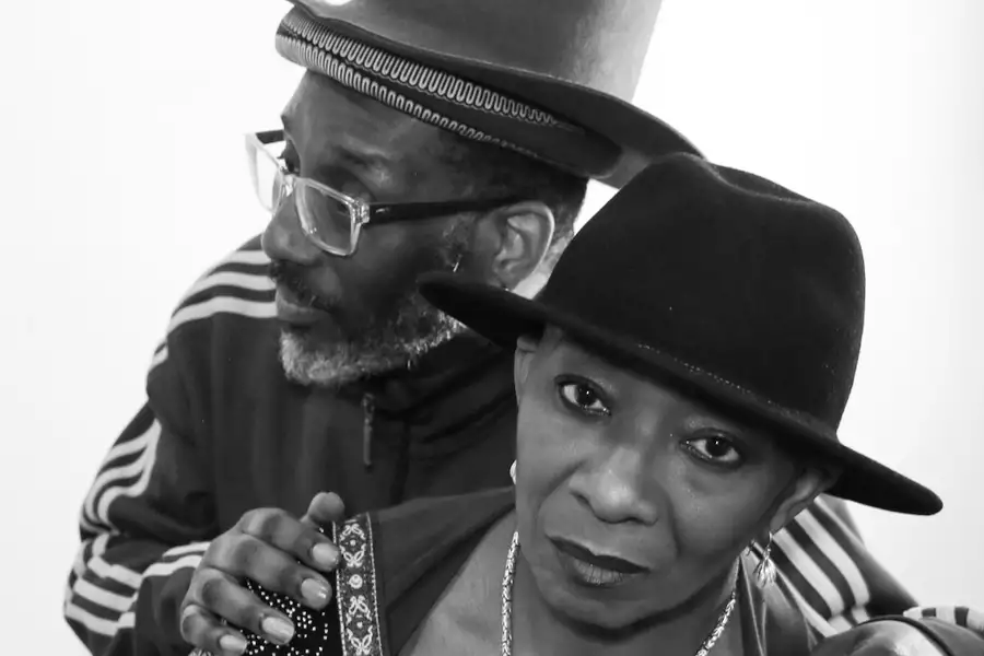 Black and white photo of Shirley May & Busha Mann smiling and hugging