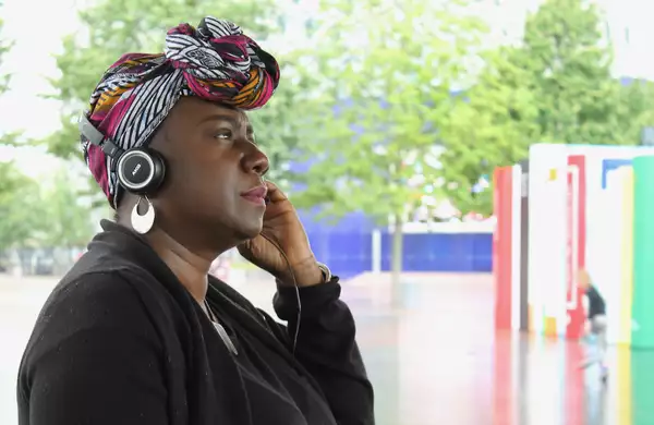 A person with headphones on looking to the side