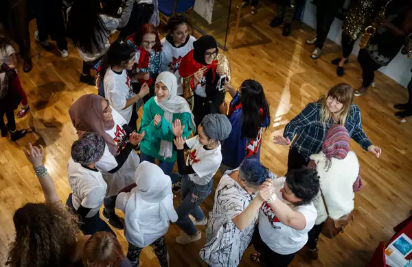 A group of people dancing and clapping