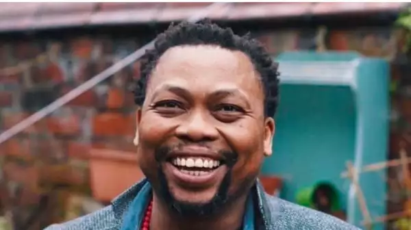 Close-up photo of Levi Love smiling. The background shows an outside area blurred.