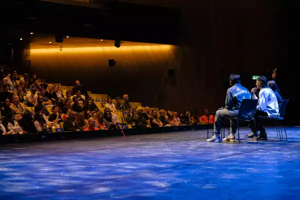 Naqqash Khalid and Nabhaan Rizwan sat on the Hall stage during the Q&A at MUBI FEST, with a large audience watching