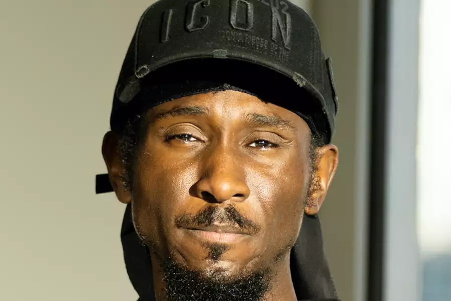 Headshot of Cephas Williams wearing a black cap that says 'icon'