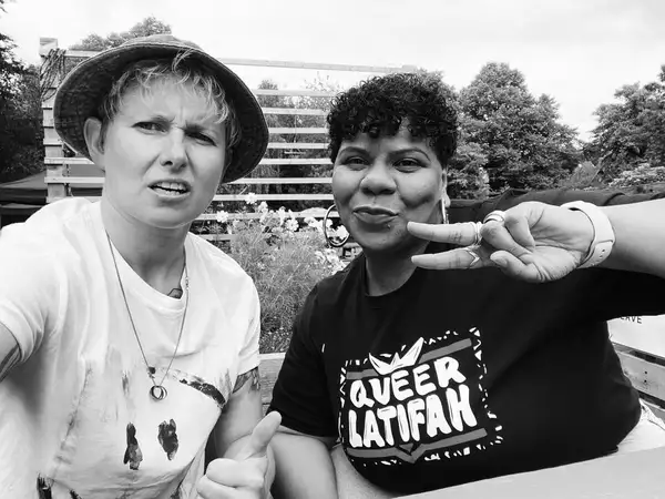 Black and white photo of two DJs for Queer Latifah