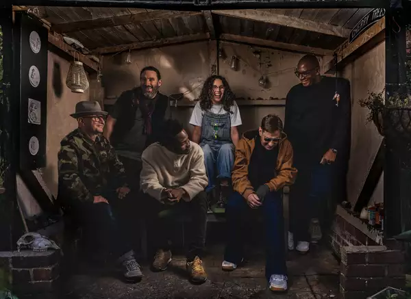 The band A Certain Ratio sitting in a garden shed