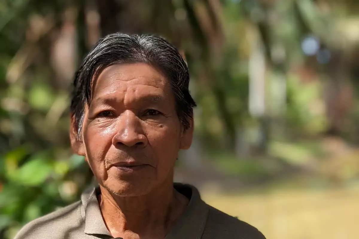 Headshot of Santiago Yahuarcani taken outside. The background is blurred.