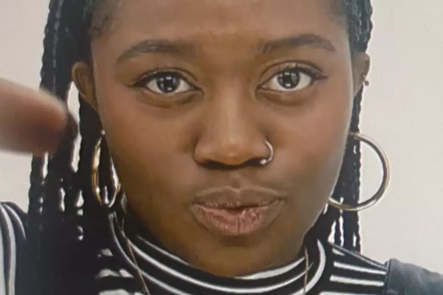 Close up photo of Oriki wearing a striped top and pouting