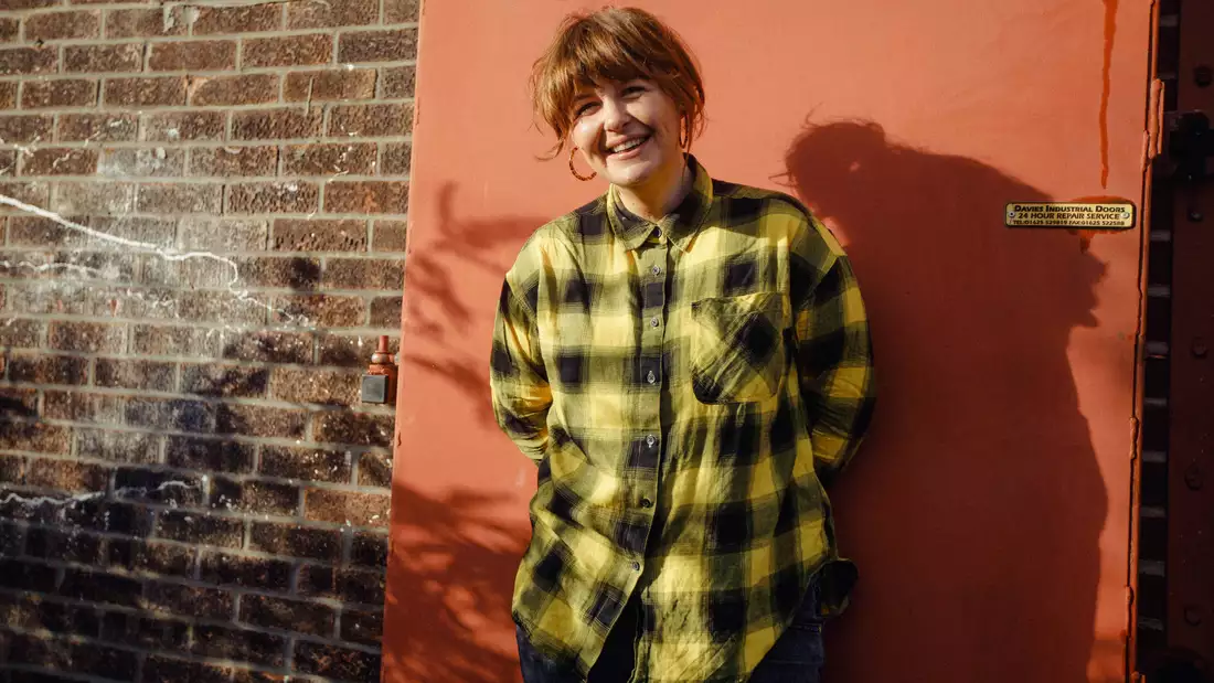 Portrait of Test Card Girl against a brick wall