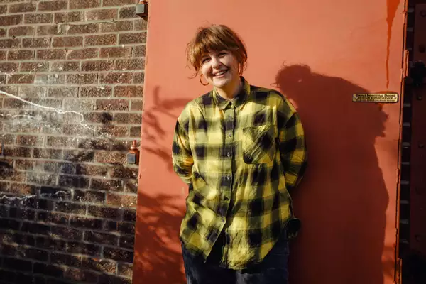 Portrait of Test Card Girl against a brick wall