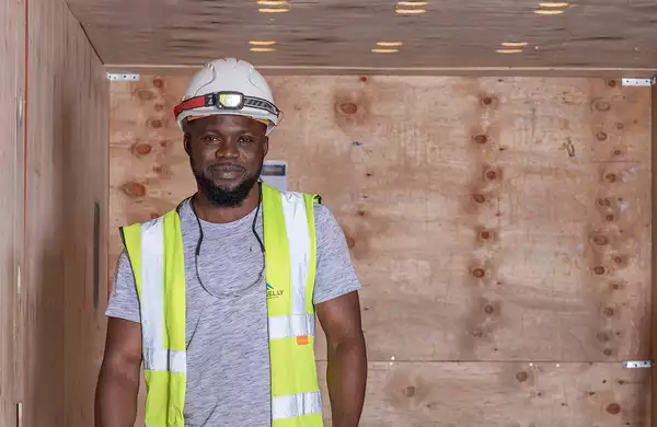 Photo of a worker wearing a helmet and hi vis
