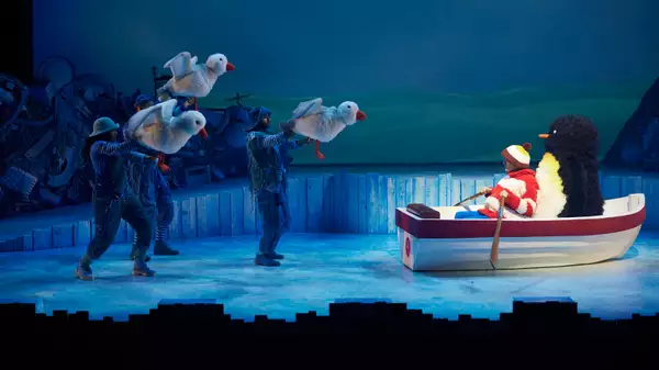 A boy and a penguin in a boat with three puppet seagulls on stage as part of Lost and Found