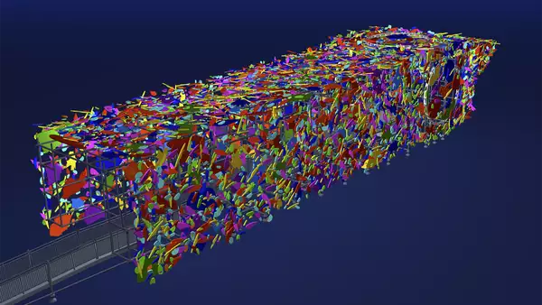 A screenshot showing a 3D model of Marta Minujín's Big Ben installation against a dark blue background. The sculpture of Big Ben is lying on it's side, and is constructed from scaffolding and clad with abstract, multi-coloured shapes. An entrance ramp on the left of the frame leads directly inside the sculpture.